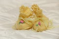 Small yellow crocheted baby slippers