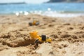 EXCAVATOR TOY ON THE BEACH SHORE WORKING WITH SAND Royalty Free Stock Photo