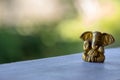 Small yellow Ganesha figure with unfocused background. Beautiful golden Ganesh statue with open palm. Asian religion concept. Royalty Free Stock Photo