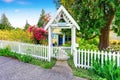 Small Yellow house exterior with White picket fence Royalty Free Stock Photo