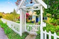 Small Yellow house exterior with White picket fence