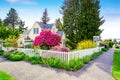 Small Yellow house exterior with White picket fence Royalty Free Stock Photo