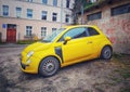 Small yellow Italian compact car Fiat 600 retro style Royalty Free Stock Photo