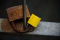 Small yellow padlock and big old rusty padlock hanging on a bridge handrail Royalty Free Stock Photo