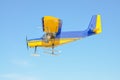 A yellow plane with a propeller on the blue sky Royalty Free Stock Photo