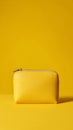 Small Yellow Pouch on Bright Yellow Background in Simple Studio Setup Royalty Free Stock Photo