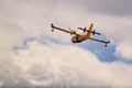 Small yellow red seaplane hydroplane flying in the sky