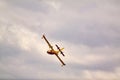 Small yellow red seaplane hydroplane flying in the sky