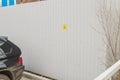 Small yellow sign on a metal fence informing about Parking for disabled people, poor awareness, poor organization of Parking for Royalty Free Stock Photo