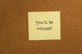 Small yellow sticky note on office noticeboard