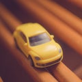 Small yellow toy car on the brown road Royalty Free Stock Photo