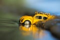 Small yellow toy car in ocean Royalty Free Stock Photo