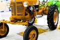 Small yellow tractor in exhibition, closeup details, wheels Royalty Free Stock Photo