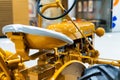 Small yellow tractor in exhibition, closeup details, wheels Royalty Free Stock Photo