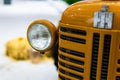 Small yellow tractor in exhibition, closeup details, wheels Royalty Free Stock Photo