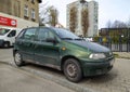 Old Italian popular compact car dark green Fiat Punto four doors parked