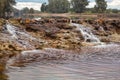 Smalls waterfalls produced by the rain in the red river Royalty Free Stock Photo