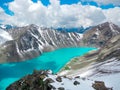 Smaragd water of misty Ala Kul lake in Terskey Alatoo mountains, Karakol national park, Kyrgyzstan