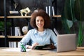 Smart and ambitious african-american female office employee using laptop compute Royalty Free Stock Photo
