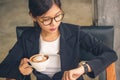 Smart Asian business woman holding mocha latte art coffee.