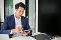 Smart Asian businessman focuses on rechecking business documents Royalty Free Stock Photo