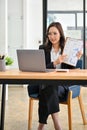 Smart Asian female accountant having an online meeting, presenting her financial data Royalty Free Stock Photo