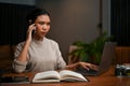 Smart Asian female boss having a serious talk on the phone with her business partner Royalty Free Stock Photo