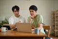 A smart Asian male college student is studying an online lesson at home together Royalty Free Stock Photo