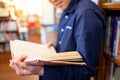 Smart Asian man student reading book in library