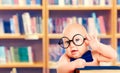 Smart Baby in Glasses with Book, Little Child in School Library Royalty Free Stock Photo