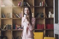 Smart beautiful young woman in headphones with a glass of coffee Royalty Free Stock Photo