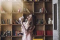 Smart beautiful young woman in headphones with a glass of coffee