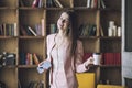 Smart beautiful young woman in headphones with a glass of coffee Royalty Free Stock Photo