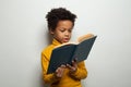 Smart black child boy reading a book on white background Royalty Free Stock Photo