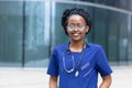 Smart black girl medical student in glasses, happy young african american woman doctor, nurse in blue uniform, stethoscope Royalty Free Stock Photo