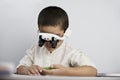 A smart boy with headband magnifying glass Royalty Free Stock Photo