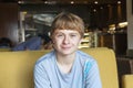 Smart boy sitting in a fastfood Royalty Free Stock Photo