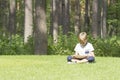 Smart boy using a tablet outdoors. Casual clothes. Technology, lifestyle, education, people concept Royalty Free Stock Photo