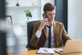 Smart businessman calling telephone at office table. Executive manager talking cell phone. handsome manager sitting at office Royalty Free Stock Photo