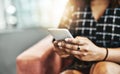 Smart businesswomen opt for smart devices. an unrecognizable businesswoman using a smartphone while sitting on a couch