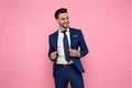 Smart casual man goofing around on pink background Royalty Free Stock Photo
