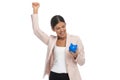 Smart casual woman celebrating and showing blue piggy bank