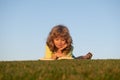 Smart child boy reading book in park outdoor. Clever kids read book in nature background. Royalty Free Stock Photo