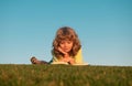 Smart child boy reading book in park outdoor. Clever kids read book in nature background. Royalty Free Stock Photo