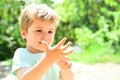 Smart child counts fingers. The boy will be five years old. A beautiful child shows his hand, a small palm. Cute kid on