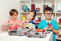 Smart children playing with educational toys. School, education, engineering and hobby concept. Kids doing school project with