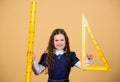 Smart and clever concept. Sizing and measuring. Pupil cute girl with big ruler. School student study geometry. Kid Royalty Free Stock Photo