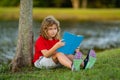 Smart clever Kids. Cute child read books outdoors. Kids learning and summer education. Child boy reading book outdoor on Royalty Free Stock Photo