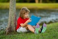 Smart clever Kids. Cute child read books outdoors. Kids learning and summer education. Child boy reading book outdoor on Royalty Free Stock Photo