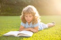 Smart clever Kids. Cute childr boy with books outdoors. Summer camp. Kids learning and education concept. Summer outdoor Royalty Free Stock Photo